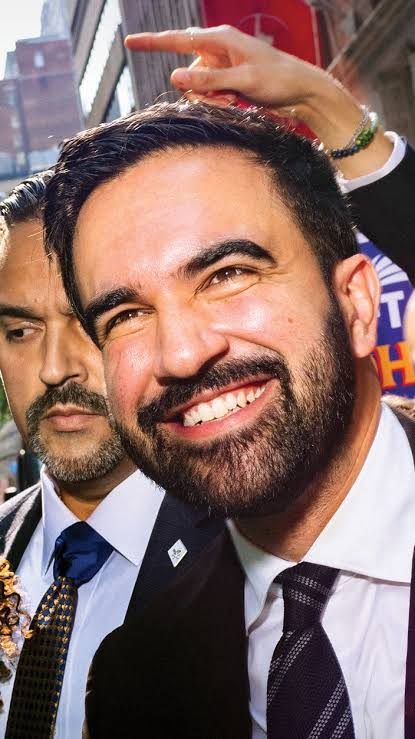 Zohran Mamdani smiling in a crowd